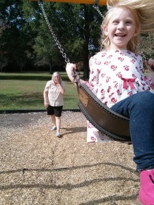 E on the swing at the playground