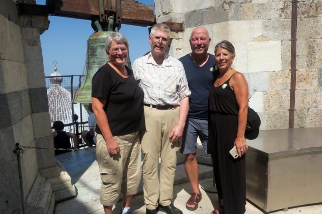 At the top of the tower at Noon. They use an recording of the bell because ringing the real bells adds too much vibration to the building.