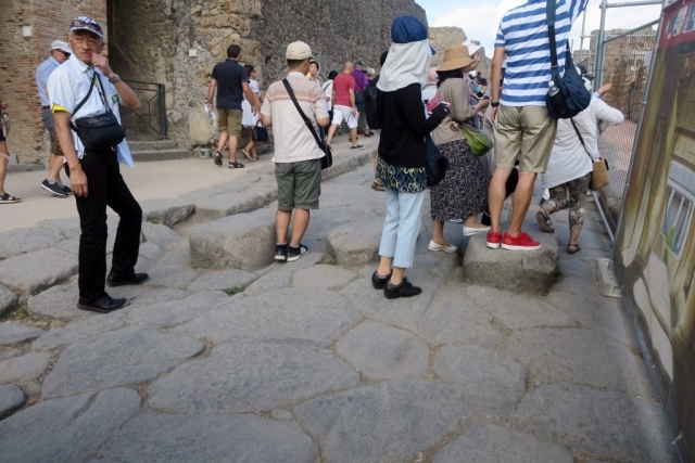 The streets were the sewers. People used these stone bridges. Only chariots used the road. One can still see the chariot ruts. The city had special chariots tall enough to clear the bridges. They used mules, not horses, because horses might try to jump the bridge.