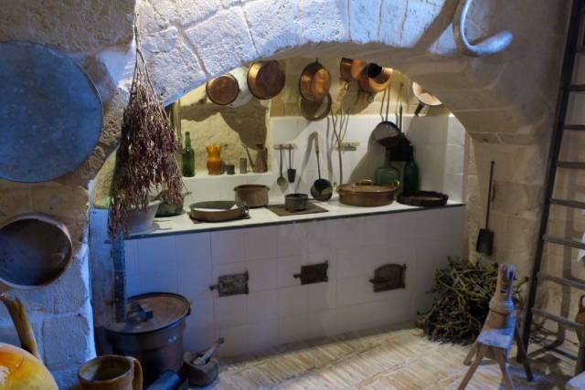 The kitchen is just inside, to the right. Like the rest of the house, it was carved from the limestone.