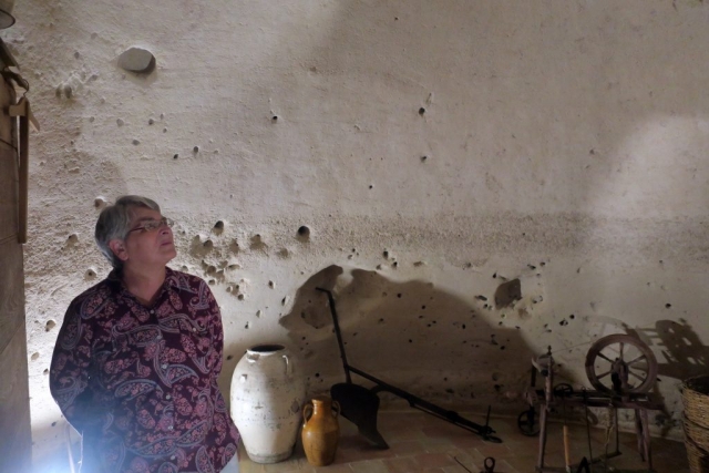 Residents captured rain water to drink. Danita is inside the cistern looking at the ceiling where ...