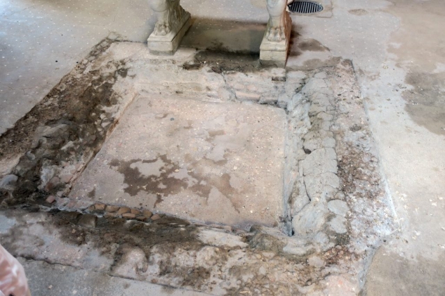 ... the owner would open this hole in the floor, letting the water in the cistern. The grate in the back is the well where they pulled water out.